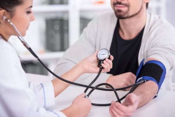 a doctor measures blood pressure in hypertension